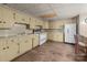 Basement kitchen with white appliances, light-yellow cabinets, and laminate countertops at 407 Pinecroft Ln, Spencer, NC 28159