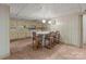 Basement kitchen with breakfast table, light-yellow cabinets, and white appliances at 407 Pinecroft Ln, Spencer, NC 28159