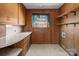 Laundry room with wood cabinets, open shelves, and lots of counter space at 407 Pinecroft Ln, Spencer, NC 28159