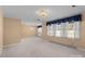 Spacious living room featuring neutral carpet, chandelier lighting, and abundant natural light at 407 Pinecroft Ln, Spencer, NC 28159