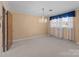 Spacious living room featuring neutral carpet, chandelier lighting, and abundant natural light at 407 Pinecroft Ln, Spencer, NC 28159