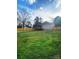 Expansive backyard featuring a large lawn, wood fence, and a charming deck at 409 Fourth St, York, SC 29745