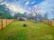 Wide backyard with fencing, a shed, and ample space for activities at 409 Fourth St, York, SC 29745