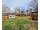 Large, fenced backyard with lush green grass and convenient shed and deck at 409 Fourth St, York, SC 29745