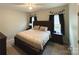 Well-lit bedroom with a large bed, bedside tables, and tasteful decorations at 409 Fourth St, York, SC 29745