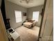 Neutral bedroom with a lounge chair and sunny windows at 409 Fourth St, York, SC 29745
