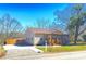 Charming single-story home with a wooden porch, landscaped yard, and a clear blue sky above at 409 Fourth St, York, SC 29745