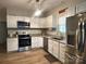 Well-lit kitchen with stainless steel appliances, granite countertops, and modern light fixture at 409 Fourth St, York, SC 29745