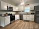 Modern kitchen featuring stainless steel appliances, white cabinets, and granite countertops at 409 Fourth St, York, SC 29745