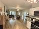 Open-concept living room with hardwood floors and a seamless transition to the kitchen at 409 Fourth St, York, SC 29745