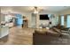 Spacious living room with hardwood floors, open floor plan to the kitchen, and neutral-toned walls at 409 Fourth St, York, SC 29745