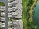 Drone shot of rooftops with manicured yards and a lake creating a picturesque and tranquil neighborhood scene at 44421 Oriole Dr # 203, Indian Land, SC 29707