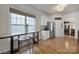 Eat-in kitchen area featuring a counter-height table with butcher block top, stools, stainless steel fridge, and light hardwood floors at 44421 Oriole Dr # 203, Indian Land, SC 29707