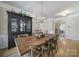 Dining area with hardwood floors, rustic wooden table and decorative chandelier at 44421 Oriole Dr # 203, Indian Land, SC 29707