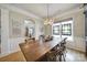 Spacious dining room with a rustic wooden table, decorative lighting, and colorful stained-glass windows at 44421 Oriole Dr # 203, Indian Land, SC 29707