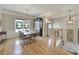Bright dining room featuring a large wooden table, unique lighting, and hardwood floors at 44421 Oriole Dr # 203, Indian Land, SC 29707