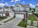 Charming two-story home featuring a two-car garage, brick accents, and well-manicured lawn and garden area at 44421 Oriole Dr # 203, Indian Land, SC 29707