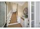 Entryway with staircase, decorated console table, and charming details at 44421 Oriole Dr # 203, Indian Land, SC 29707
