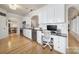Beautiful white kitchen featuring stainless appliances, granite countertops and desk, with light hardwood floors at 44421 Oriole Dr # 203, Indian Land, SC 29707