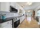 Bright kitchen featuring stainless steel appliances, granite countertops, and open access to the dining and living areas at 44421 Oriole Dr # 203, Indian Land, SC 29707