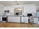 Contemporary kitchen with stainless steel appliances, white cabinets, granite countertops, and adjacent workspace at 44421 Oriole Dr # 203, Indian Land, SC 29707