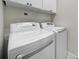 Featuring a modern white washer and dryer set with upper cabinets at 44421 Oriole Dr # 203, Indian Land, SC 29707