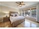 Serene bedroom with wood bed frame, hardwood floors, ceiling fan, and lake view at 44421 Oriole Dr # 203, Indian Land, SC 29707