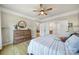 Comfortable bedroom boasts a hardwood dresser, hardwood floors, neutral colors, ceiling fan, and serene ambiance at 44421 Oriole Dr # 203, Indian Land, SC 29707