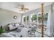 Relaxing screened-in porch with plush seating, ceiling fan, lake views, and cat tree at 44421 Oriole Dr # 203, Indian Land, SC 29707