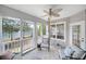 Cozy screened-in porch featuring lake views, comfortable seating, and decorative fan at 44421 Oriole Dr # 203, Indian Land, SC 29707