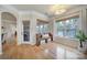 Bright sunroom area features large windows with views of the lake, bench, and access to porch at 44421 Oriole Dr # 203, Indian Land, SC 29707