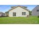 A well-manicured backyard features a sliding glass door and window, with construction visible in the background at 4465 Dusty Orchard Rd, Kannapolis, NC 28081