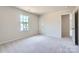 Neutral bedroom with carpet, one window, and a doorway to another room at 4465 Dusty Orchard Rd, Kannapolis, NC 28081