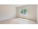 Bright, light-filled bedroom featuring a large window and light wood flooring at 4465 Dusty Orchard Rd, Kannapolis, NC 28081
