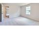 Neutral bedroom with carpet, one window, and a doorway to another room at 4465 Dusty Orchard Rd, Kannapolis, NC 28081