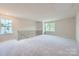 Large, open bonus room with plush carpeting, two windows, and a decorative railing at 4465 Dusty Orchard Rd, Kannapolis, NC 28081