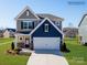 Charming two-story home featuring a gray and blue color scheme, a two-car garage, and a well-manicured lawn at 4465 Dusty Orchard Rd, Kannapolis, NC 28081