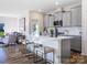 Open-concept kitchen featuring a spacious island with seating, modern gray cabinetry, and stainless steel appliances at 4465 Dusty Orchard Rd, Kannapolis, NC 28081