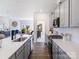 Stylish kitchen with a large island, white countertops, gray cabinets, and stainless steel appliances, open to living room at 4465 Dusty Orchard Rd, Kannapolis, NC 28081