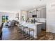 Open-concept kitchen featuring a spacious island with seating, modern gray cabinetry, and stainless steel appliances at 4465 Dusty Orchard Rd, Kannapolis, NC 28081