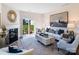 Comfortable living room featuring neutral tones, stylish furniture, a fireplace, and sliding glass doors to the backyard at 4465 Dusty Orchard Rd, Kannapolis, NC 28081