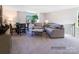 Relaxing living space featuring neutral tones, comfortable seating, and ample natural light at 4465 Dusty Orchard Rd, Kannapolis, NC 28081