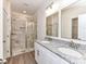 Modern bathroom with marble-look tile shower and double sink vanity with granite countertop at 5609 Morgan Mill Rd, Monroe, NC 28110