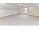 Spacious bedroom featuring neutral carpet, natural light, and ample open floor space at 5609 Morgan Mill Rd, Monroe, NC 28110