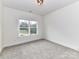Neutral bedroom featuring carpet and natural light from the window at 5609 Morgan Mill Rd, Monroe, NC 28110