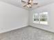 Bright bedroom featuring carpet, a ceiling fan, and natural light from the window at 5609 Morgan Mill Rd, Monroe, NC 28110