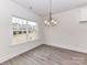 Well-lit dining room with a large window and modern chandelier at 5609 Morgan Mill Rd, Monroe, NC 28110