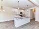 Bright open kitchen with granite countertops, stainless appliances, and modern pendant lighting at 5609 Morgan Mill Rd, Monroe, NC 28110
