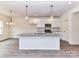 Bright kitchen featuring a center island with pendant lights, stainless steel appliances, and white cabinetry at 5609 Morgan Mill Rd, Monroe, NC 28110