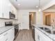 Modern kitchen featuring white cabinets, stainless appliances, granite counters, and subway tile backsplash at 5609 Morgan Mill Rd, Monroe, NC 28110